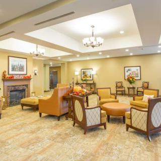 A well-furnished lobby with comfortable seating, elegant chandeliers, and tasteful decor.