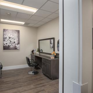 A modern hair salon interior with a chair and mirror setup.