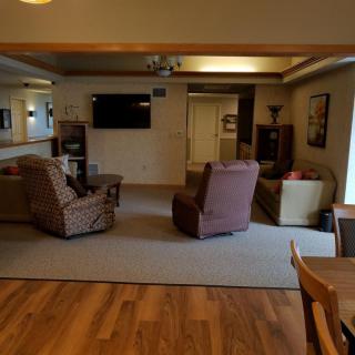 A cozy living room with comfortable seating and a television setup.