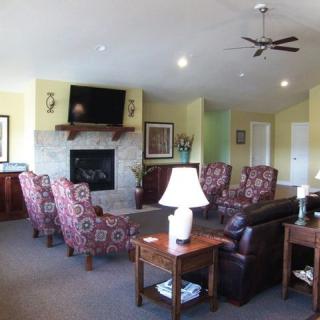 A cozy living room with a fireplace, television, and comfortable seating.