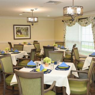 A well-decorated dining room with elegantly set tables and comfortable chairs.