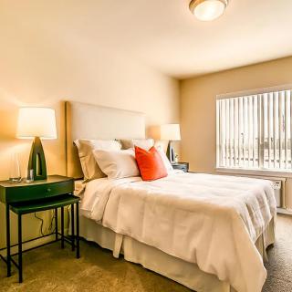 A cozy and modern bedroom with minimalistic decor, featuring a comfortable bed and stylish lamps.