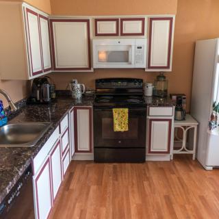 A cozy kitchen with modern appliances and wooden cabinets.