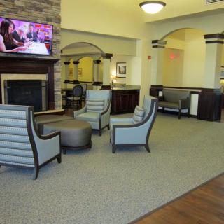 A modern lobby with comfortable seating and a fireplace.