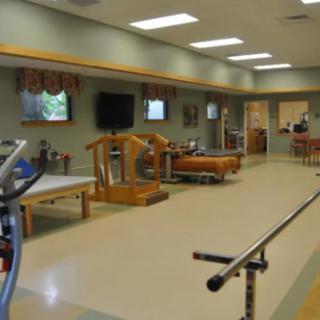 A well-equipped physical therapy room with various exercise equipment for rehabilitation.