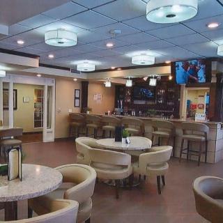 A modern restaurant interior featuring a bar counter and comfortable seating.