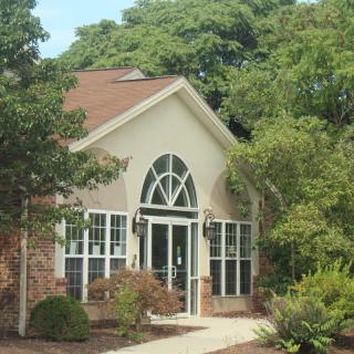 A picturesque house surrounded by lush greenery.