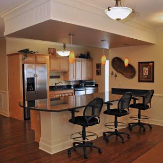 A modern kitchen featuring bar stools and an open design, perfect for entertaining.