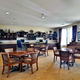 A spacious, well-lit library or study area with computers, tables, and bookshelves.