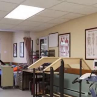 A therapy room in a rehabilitation center with various medical and exercise equipment.