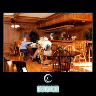A cozy dining area with wooden furnishings where people are enjoying a meal.
