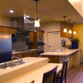 A modern kitchen interior with stylish lighting and a spacious countertop.