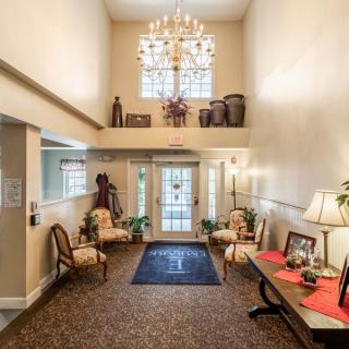 Elegant lobby with a grand chandelier and classic decor.