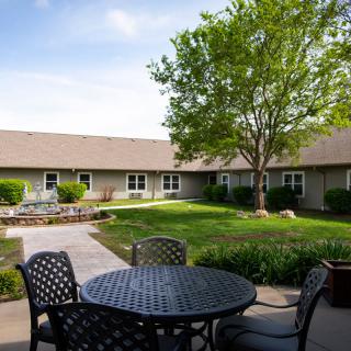 A peaceful courtyard with outdoor seating and a landscaped garden.