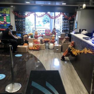 A lobby decorated with pumpkins and autumn-themed garlands for the fall season.