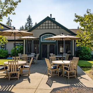 A charming outdoor caf with wooden tables and umbrellas, perfect for enjoying a sunny day.