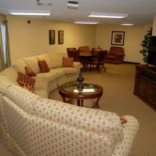 A spacious living room with a sectional sofa and a TV.