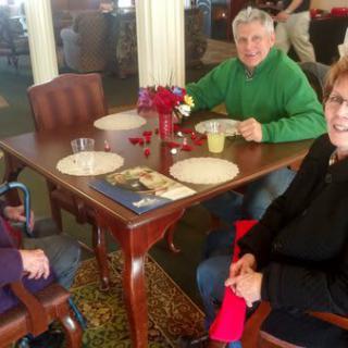 Three people sitting at a table in a restaurant.
