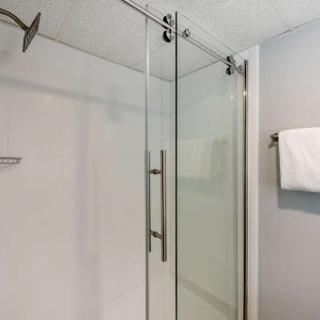 A sleek and modern glass shower enclosure in a stylish bathroom.