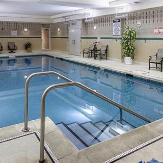 An indoor swimming pool with seating and decor, offering a space for relaxation and leisure.