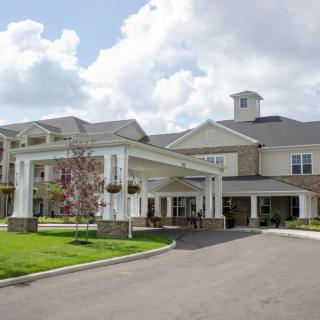 A modern residential or facility building with a covered entrance.