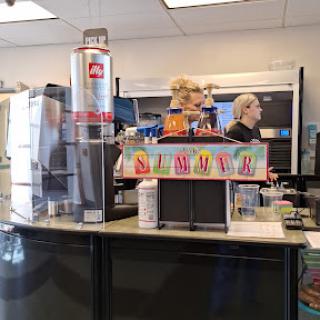A busy fast food restaurant counter with employees serving customers.