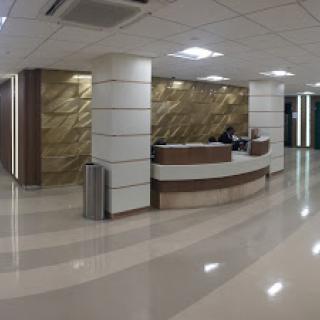 A modern office lobby with a reception desk and elegant interior design.