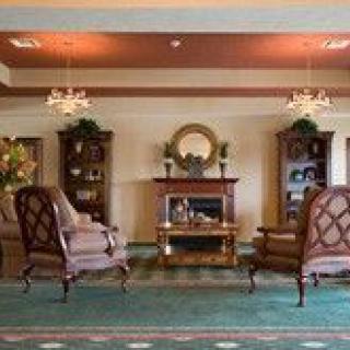An elegant living room with a cozy fireplace and traditional furnishings.