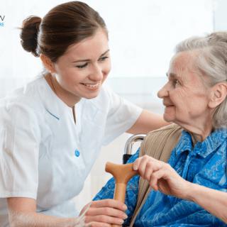 A nurse providing care and support to an elderly woman.