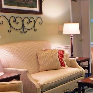 A cozy living room with a comfortable sofa, stylish lamps, and decorative elements.