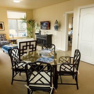 A cozy living room with a dining area featuring stylish furniture and decor.