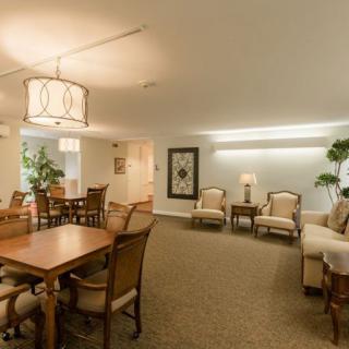 A spacious living and dining area with modern furnishings and soft lighting.