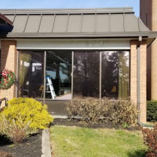 A view of the exterior glass facade of a commercial building.
