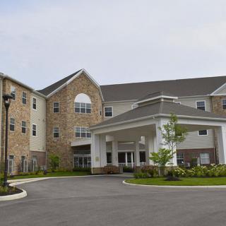 A modern residential building with a welcoming entrance and well-maintained landscaping.