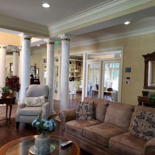 A cozy living room featuring elegant pillars and comfortable seating.