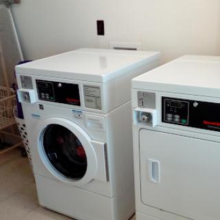 A modern washing machine and dryer set in a laundry room.