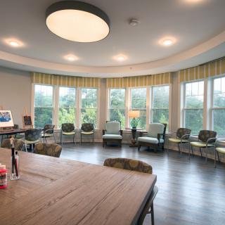 A spacious room with large windows, ample seating, and abundant natural light.