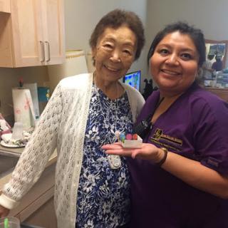 A joyful moment shared between an elderly woman and her caregiver.