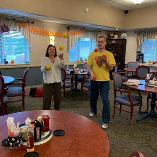 Participants enjoying a juggling activity in a community space.