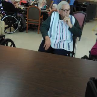 Elderly residents enjoying time together in a community care facility.