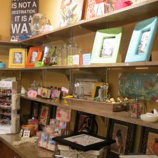 A gift shop display featuring shelves filled with picture frames, decorations, and various merchandise.