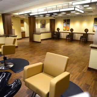 A modern salon interior with stylish chairs and warm lighting.