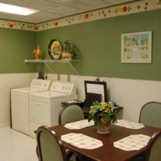 A cozy laundry room with a dining table and decorative elements.