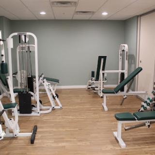 A well-equipped gym space featuring various strength training machines.