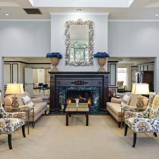 Elegant living room with a cozy fireplace and stylish furniture arrangement.