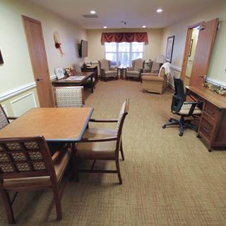 A spacious office interior with desks, chairs, and a table.