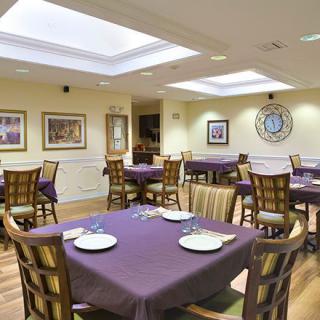 An elegant dining room with neatly arranged tables and chairs, ready for guests.