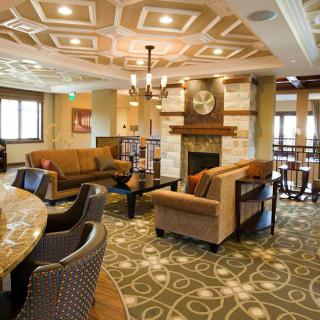 A modern lounge area with comfortable seating and a fireplace.