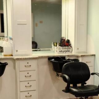 An interior view of a barbershop with chairs and mirrors.