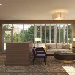 A modern lobby area with comfortable seating and large windows allowing natural light.